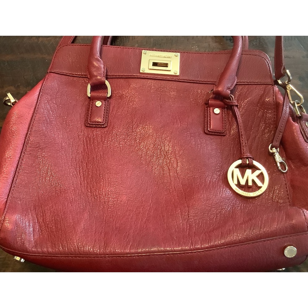 Michael Kors large burgundy satchel with satin storage bag.